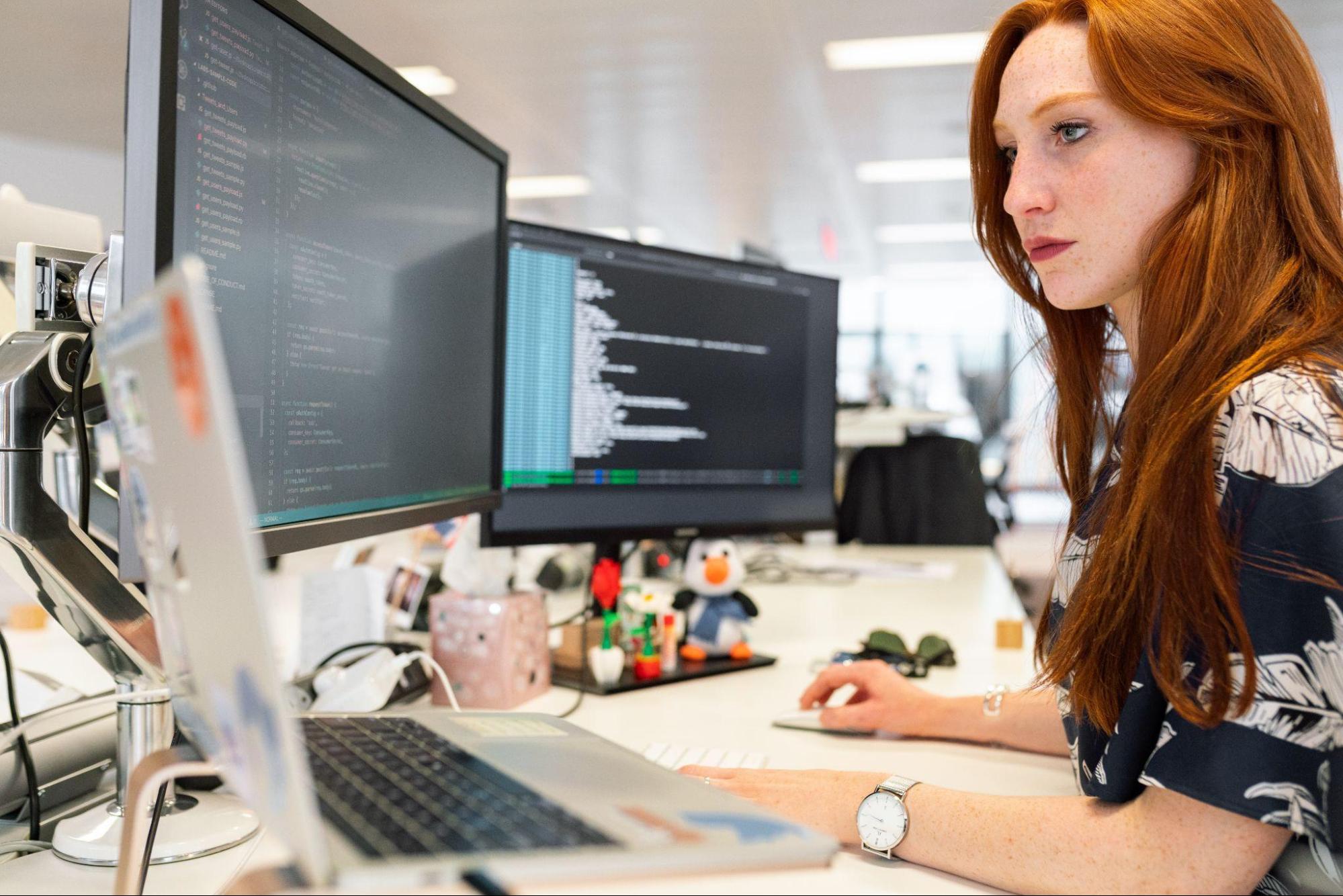 a woman working at her desk on a computer